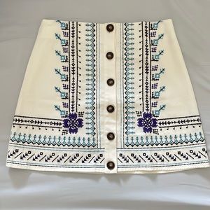 White skirt with blue embroidery